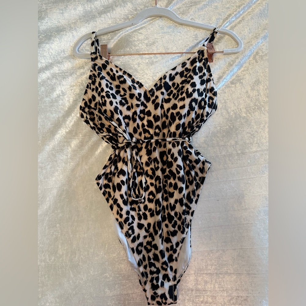 One piece leopard swim suit with tie around waist. Size medium